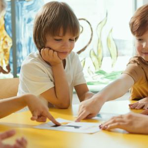 Kids looking a paper together